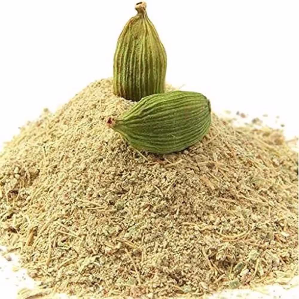 Cardamom spice powder with two pods on it