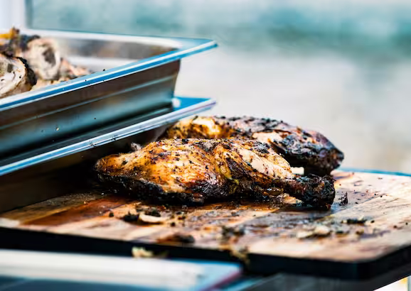 An image of our tasty jerk chicken and spice on our Alberta slow cook in our over on cast iron and finished on the smoker